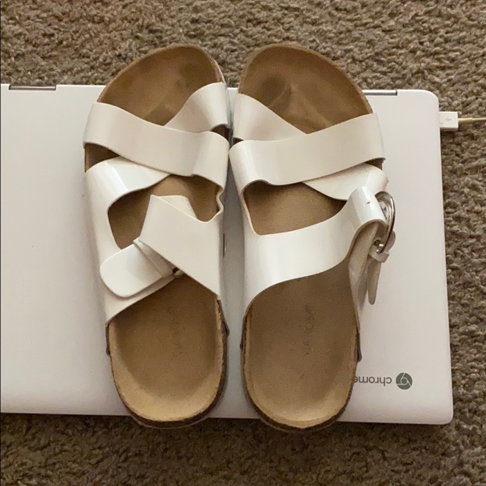 White cross sandals with silver buckle